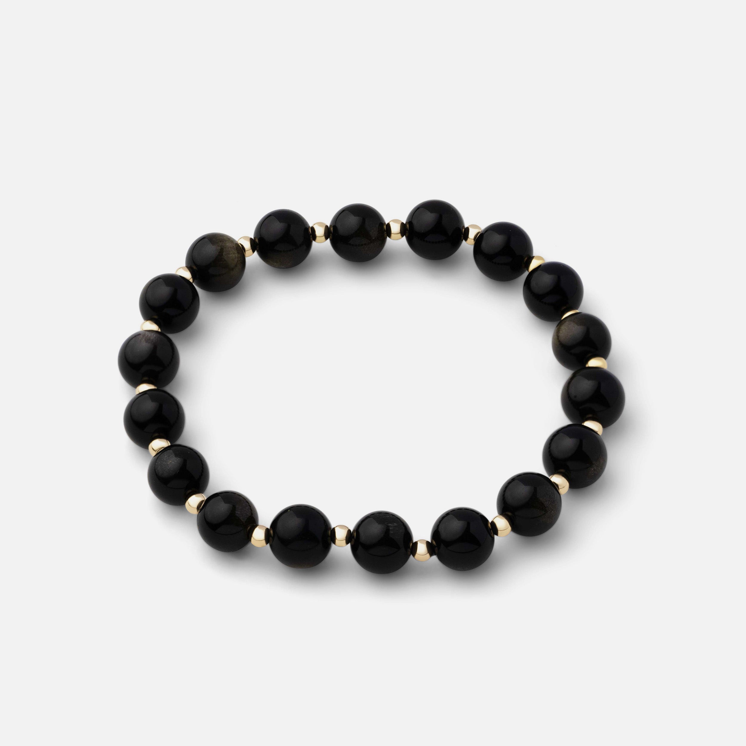 Bold and effortless bracelet made with natural black obsidian gemstone beads, exuding powerful and resilient qualities, perfect for wearing alone or layered with other pieces.