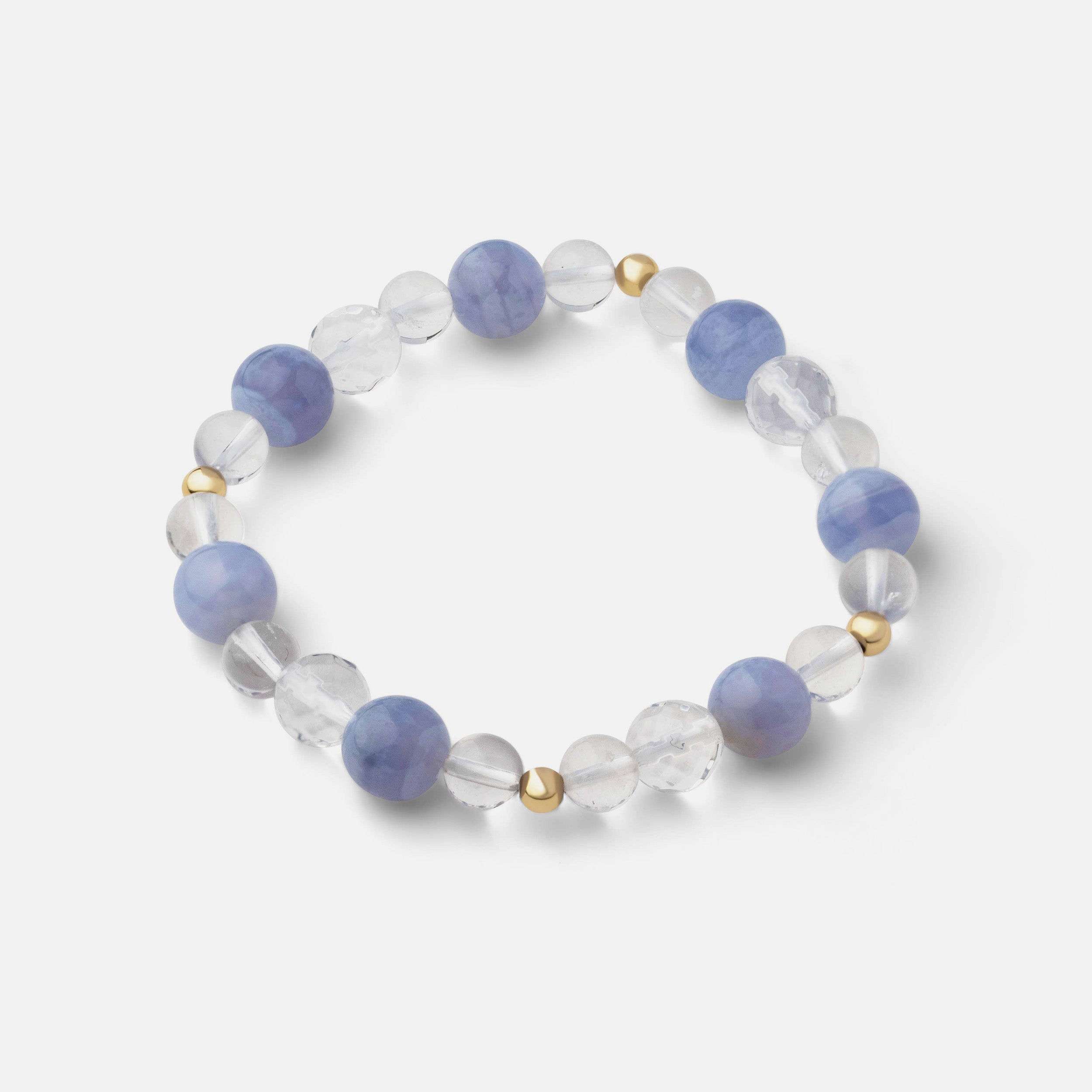 Exquisite blue lace agate bracelet with bands ranging from light to sapphire blue, complemented by clear quartz that adds a beautiful blue hue and gorgeous flair to any outfit, perfect for wearing solo or stacked with other bracelets.