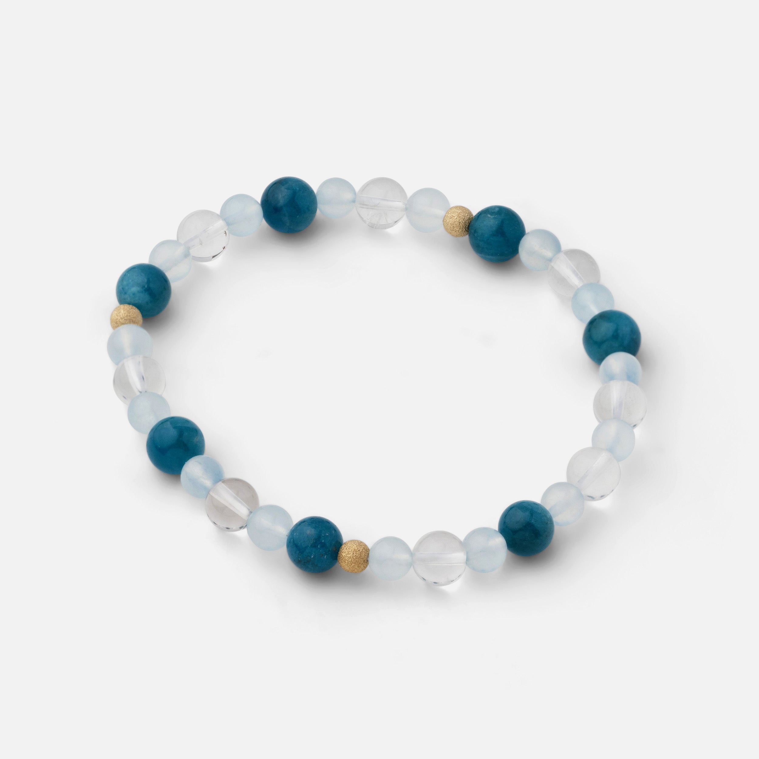 Bracelet with small beads (4-8mm) of electric blue apatite, clear blue aquamarine, and clear quartz, inspired by the cool refreshment of beach waves and the beauty of the ocean, perfect for wearing solo or stacked with other pieces.