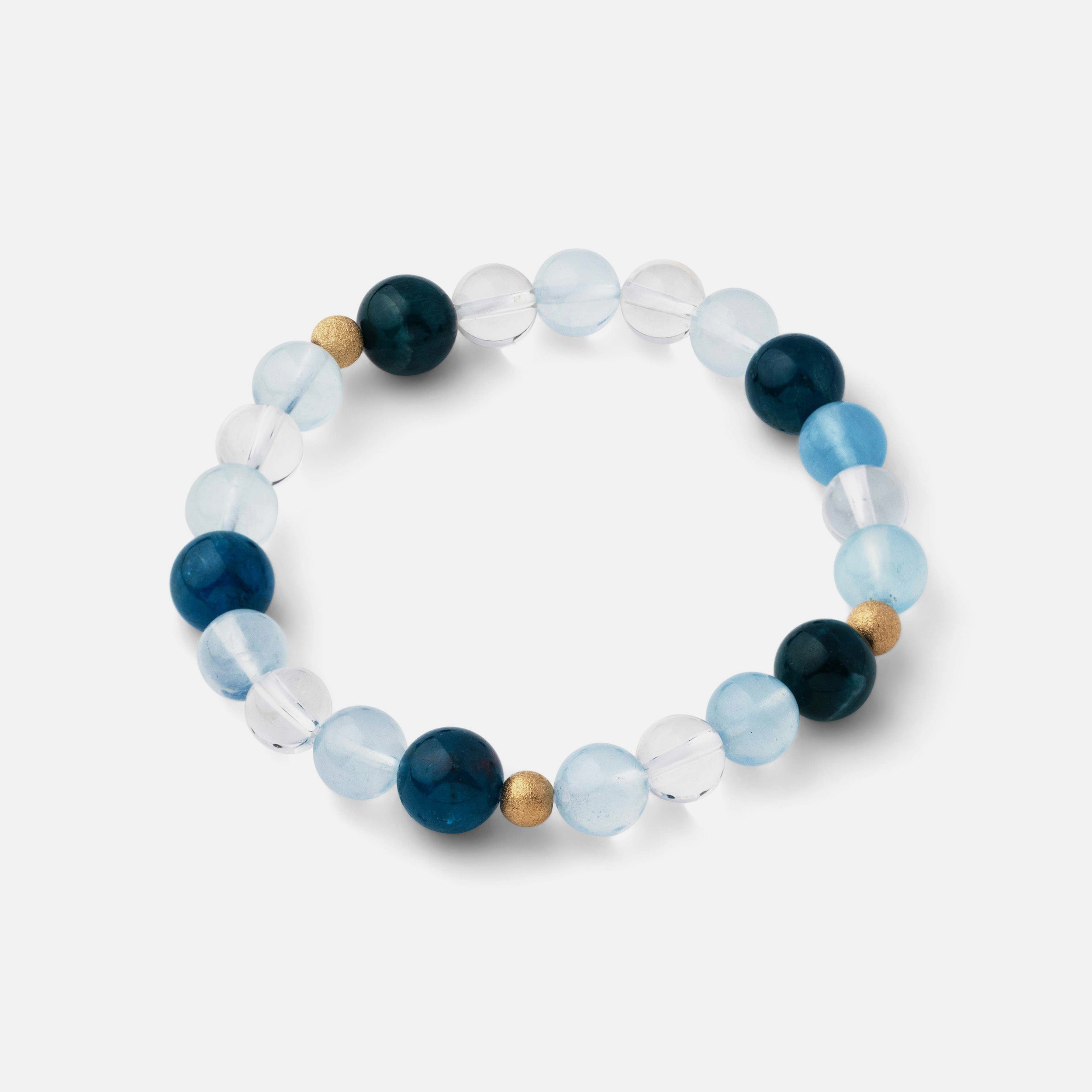 Bracelet with medium-sized beads (5-9mm) of electric blue apatite, clear blue aquamarine, and clear quartz, inspired by the cool refreshment of beach waves and the beauty of the ocean, perfect for wearing solo or stacked with other pieces.