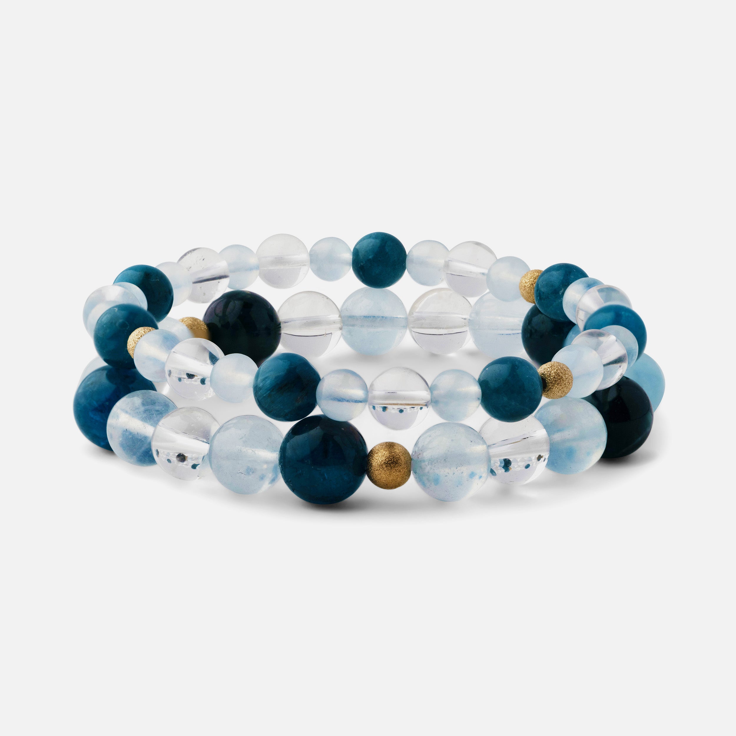 A small-sized bead bracelet stacked on top of a medium-sized bead bracelet, featuring electric blue apatite, clear blue aquamarine, and clear quartz, showcasing the versatility and ocean-inspired beauty of the pieces.