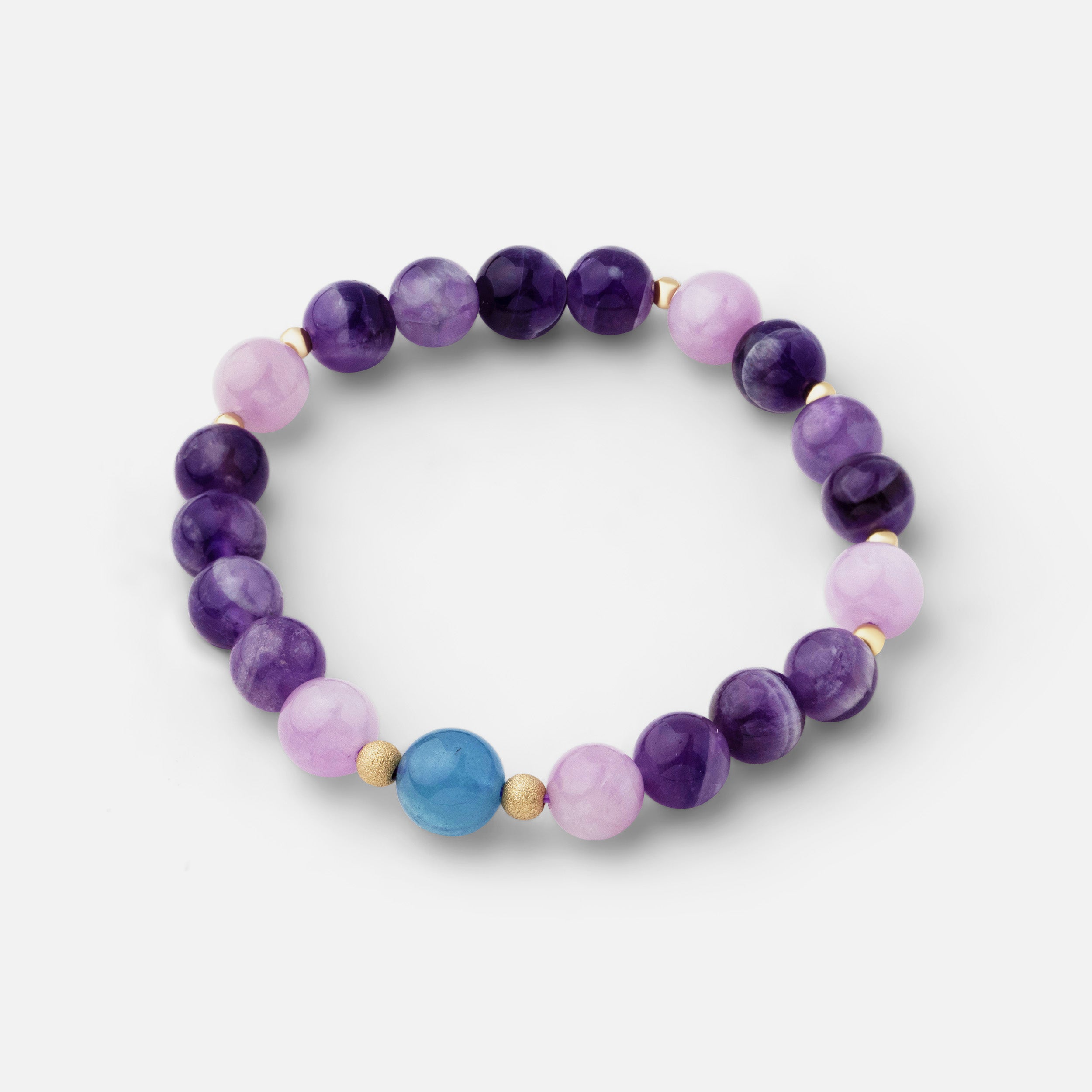 Bracelet featuring unique v-shaped and banded patterns of dream amethyst, light pink rose quartz, pale pink and lavender kunzite, and blue aquamarine, offering a timeless style that can be worn alone or layered with other gold pieces.