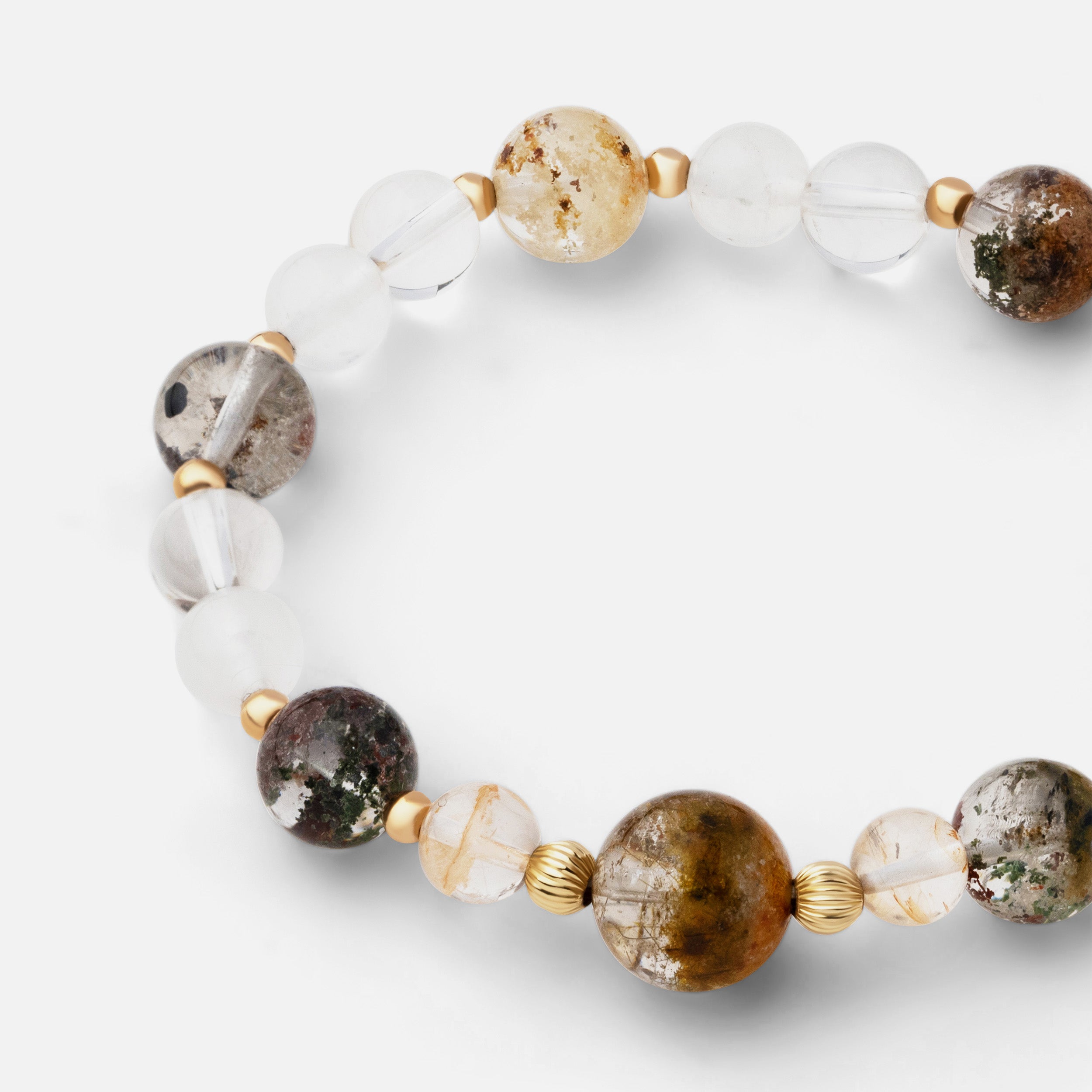 Close-up of a delicate and versatile bracelet, showcasing the beautiful inclusions within garden quartz, paired with flashy moonstone and clear quartz, perfect for day-to-night wear.