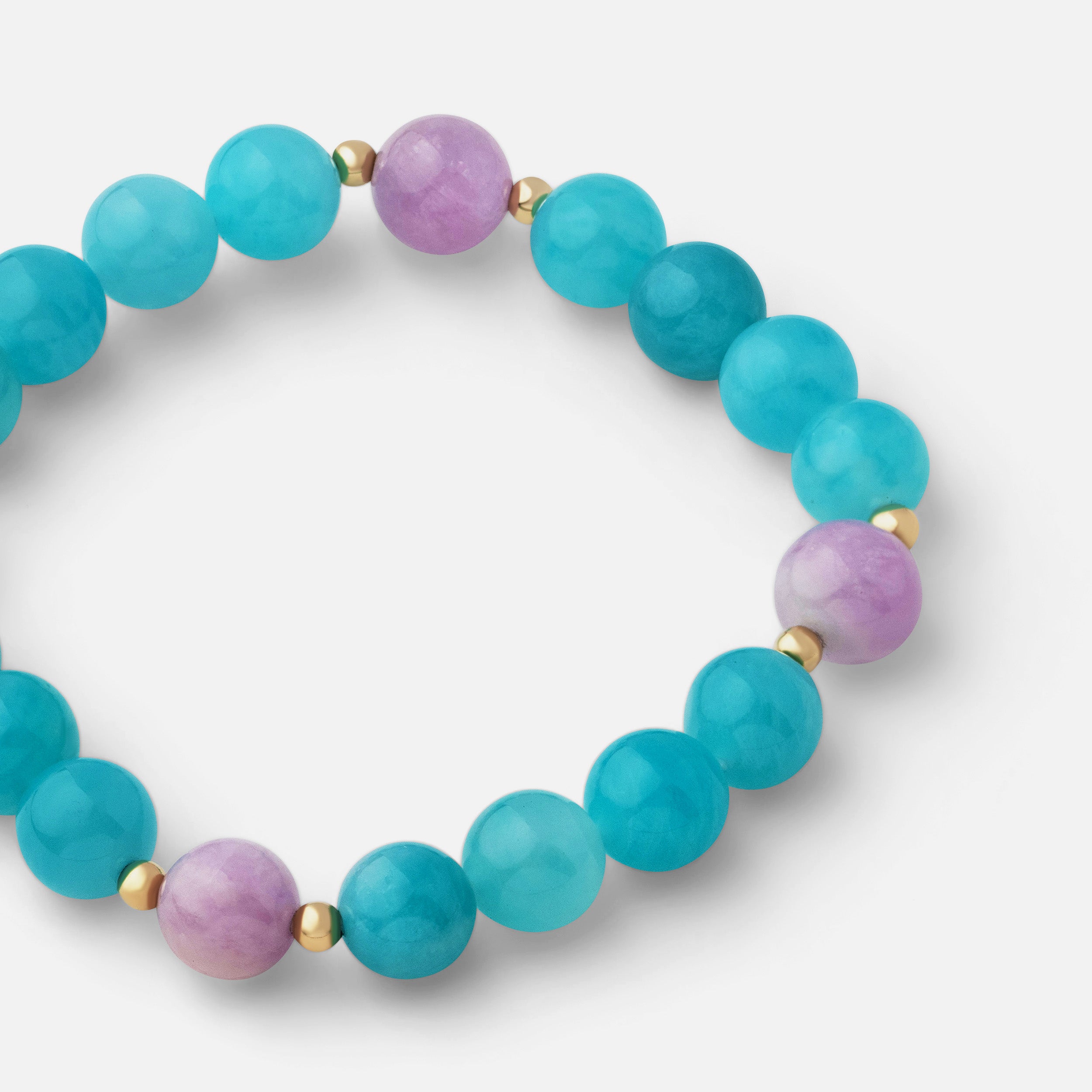 Close-up of a bracelet featuring stunning ocean blue ice amazonite paired with pale pink and lavender kunzite, perfect for vacation-ready styles. Can be worn alone or stacked with other gold pieces.