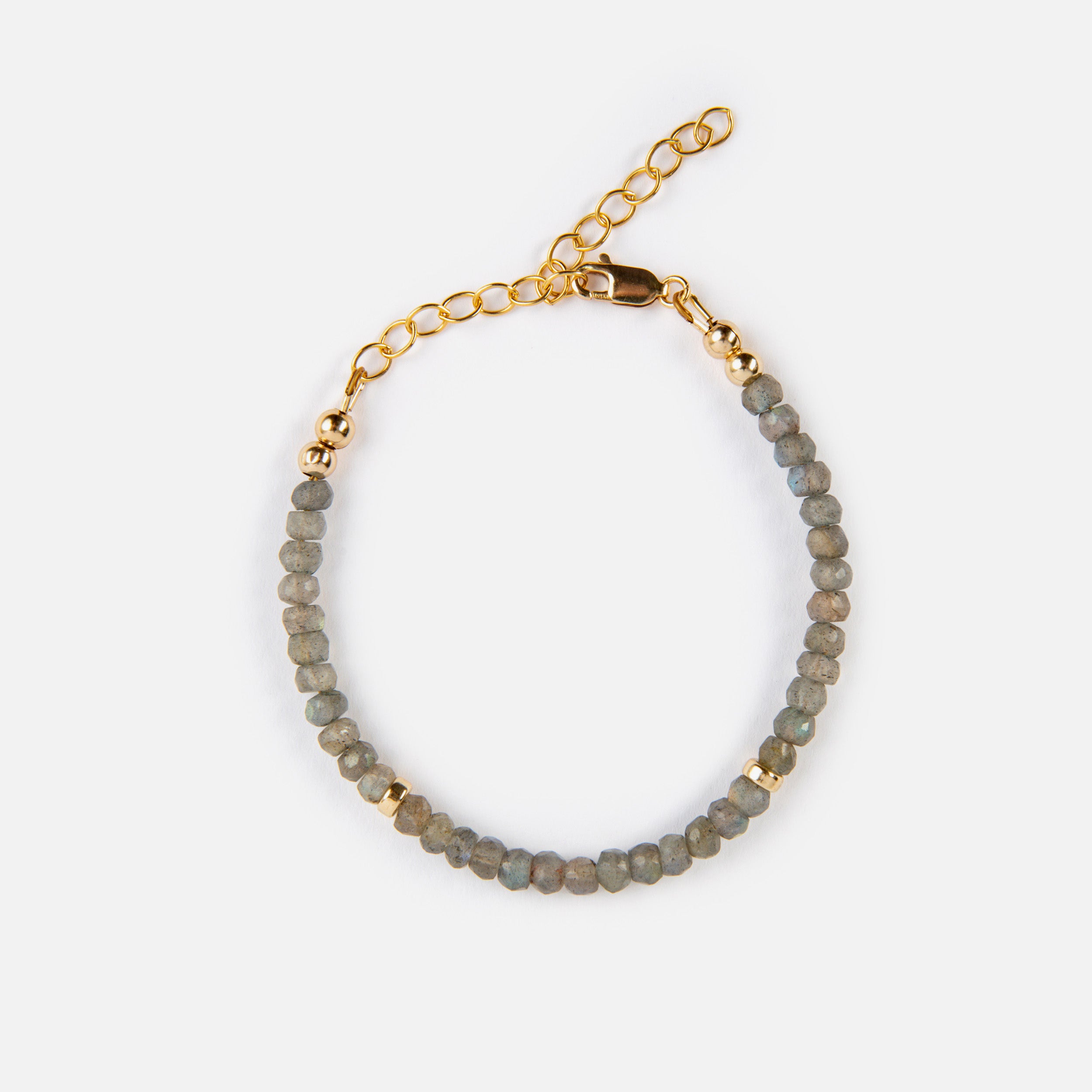 The stunning, shimmering blue of the labradorite bracelet is sophisticated and timeless, making it ideal for layering with other gold necklaces.